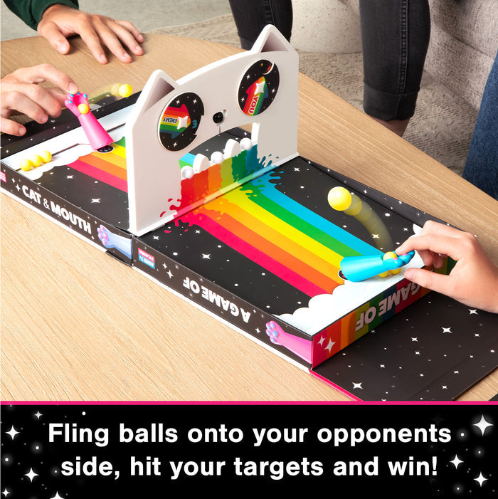 Hands flicking balls across the Cat & Mouth pinball board