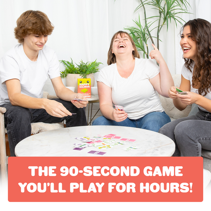 Three friends playing Happy Salmon Grab & Game at a table