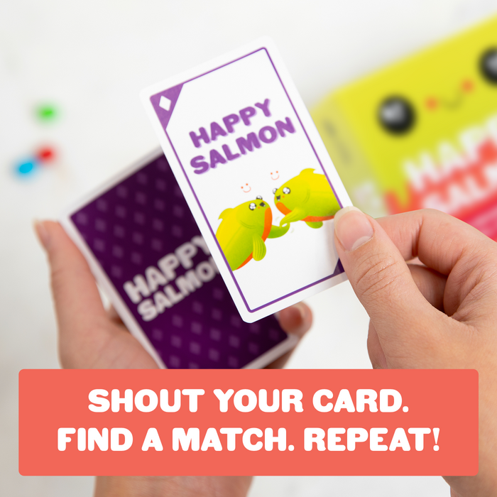 A hand holding a Happy Salmon card; shout your card, find a match