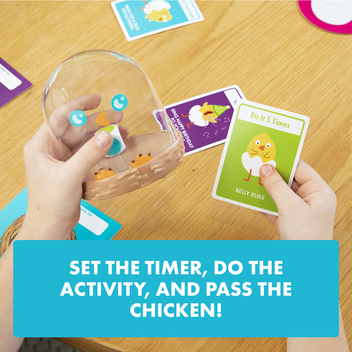 A hand holding the Hurry Up Chicken Butt shaker and cards