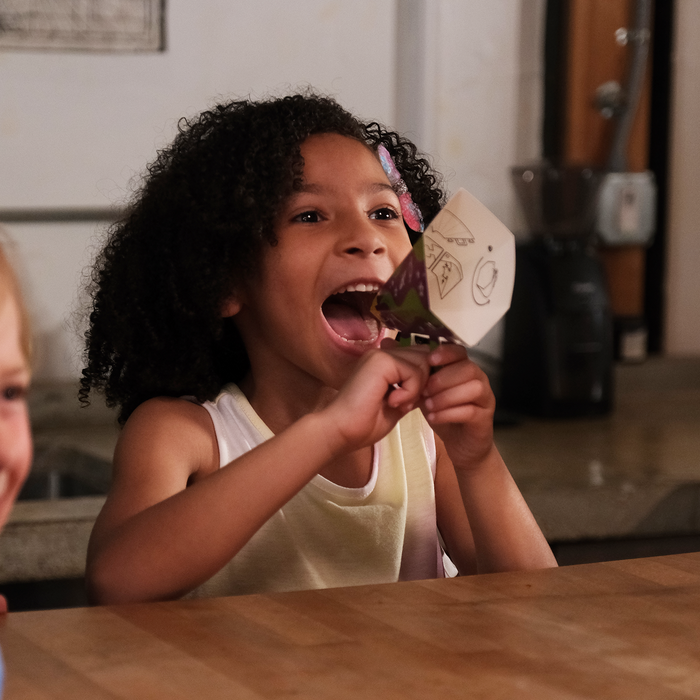 A child laughing while playing My Parents Might Be Martians