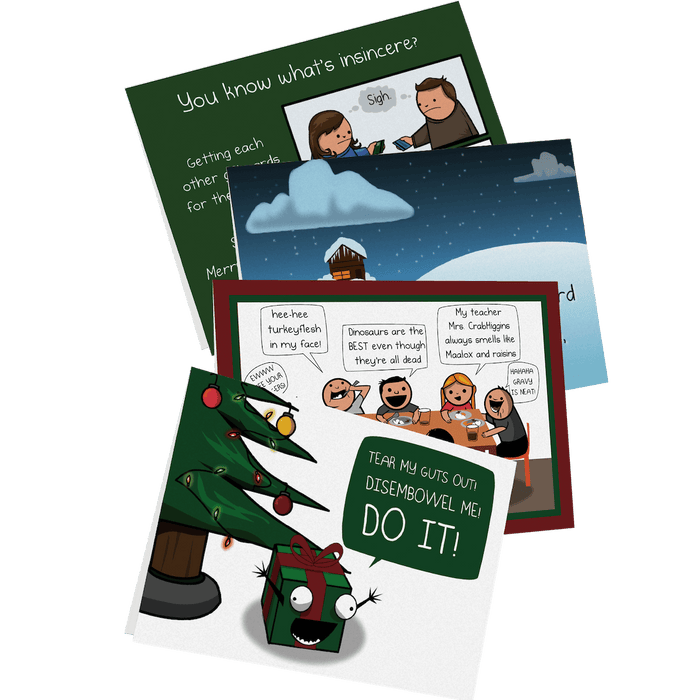 Four adult-humor holiday greeting cards fanned out beside a decorated Christmas tree