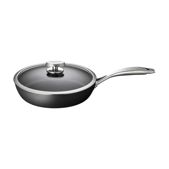 Black frying pan with a lid on a white background