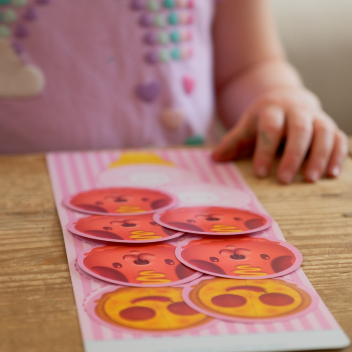 Child playing The Best Worst Ice Cream with face-shaped scoop cards