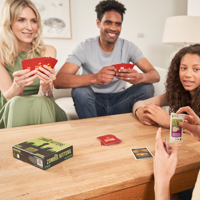 Family playing Zombie Kittens at a table